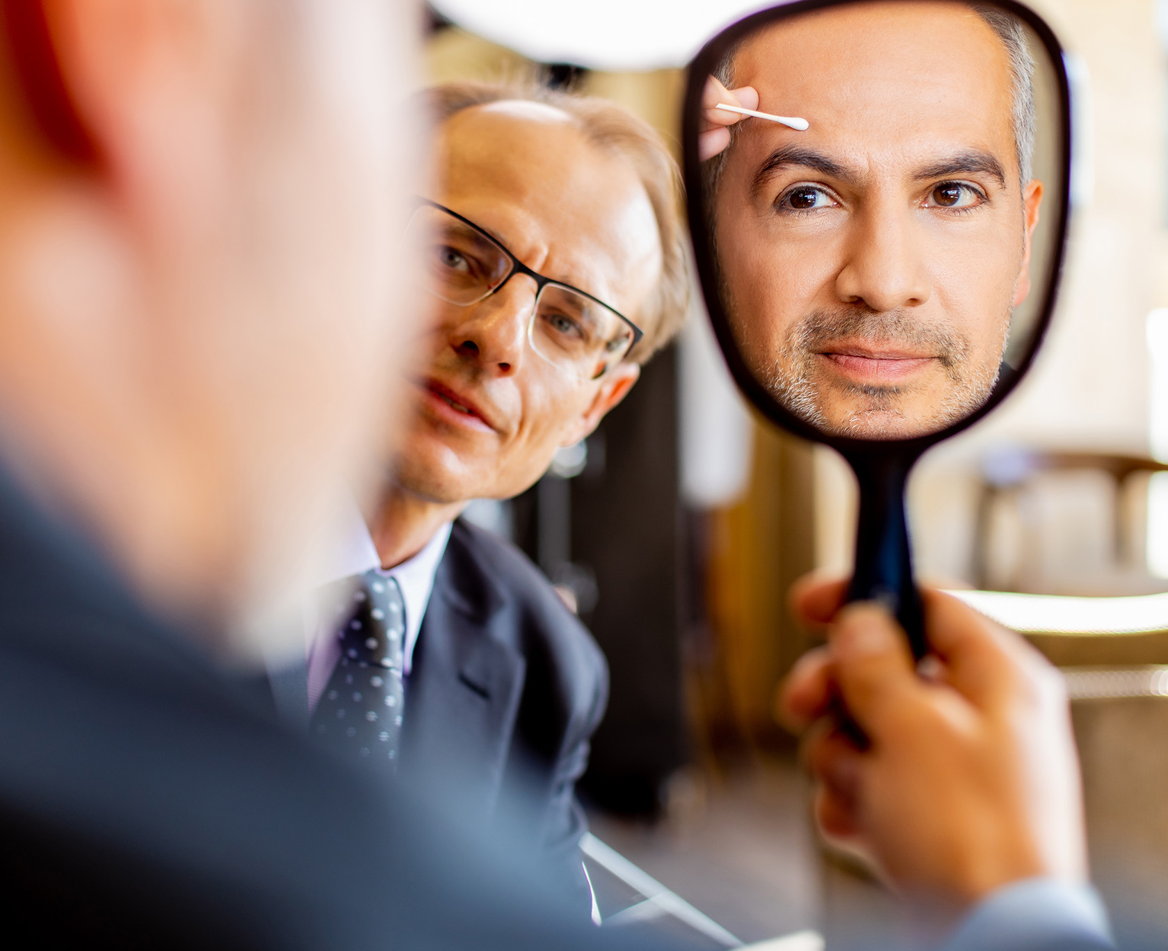 there is a man looking at himself in the mirror with Dr. Wojciech Przylecki from The LaVie Institute