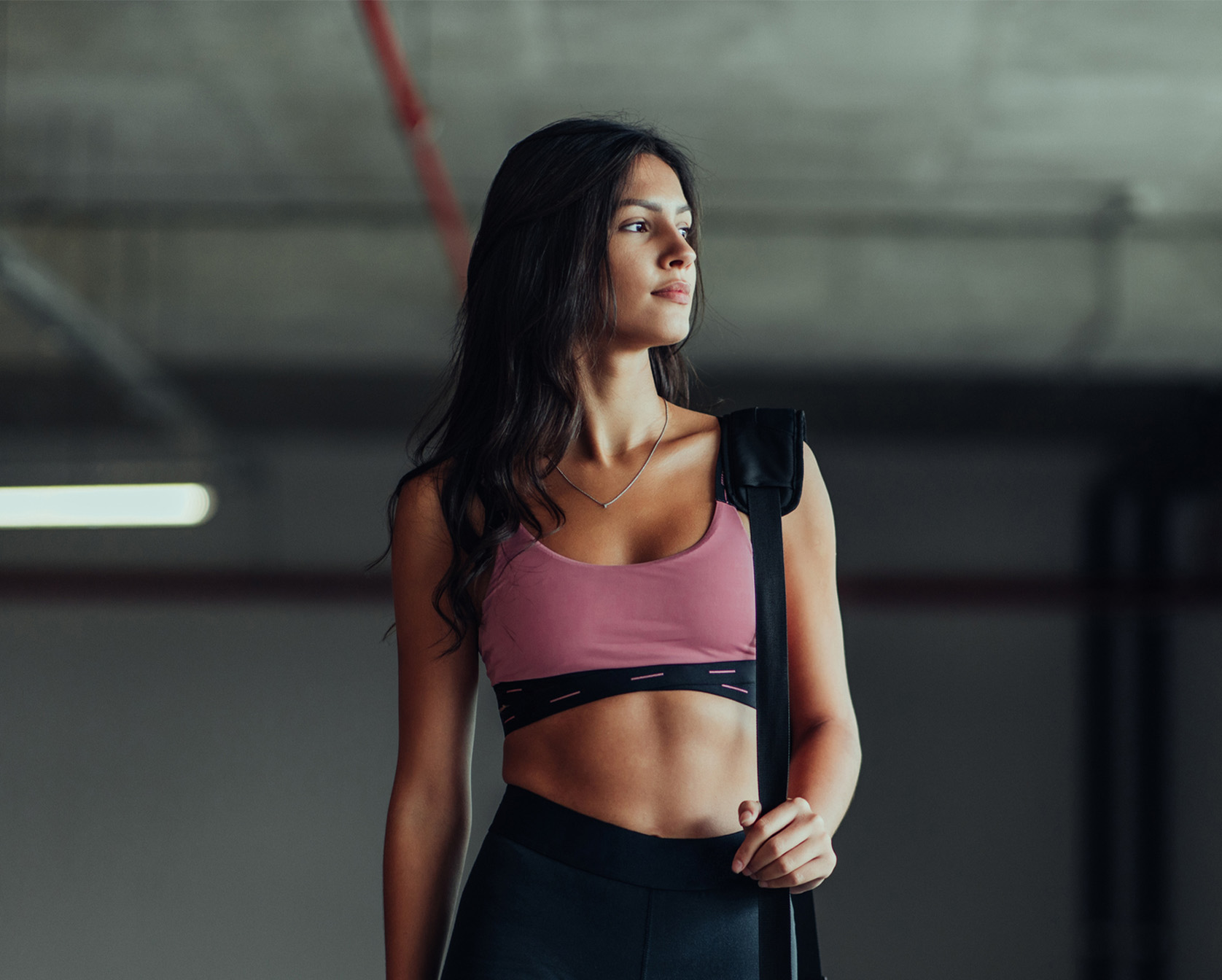 Woman in workout clothes holding a bag