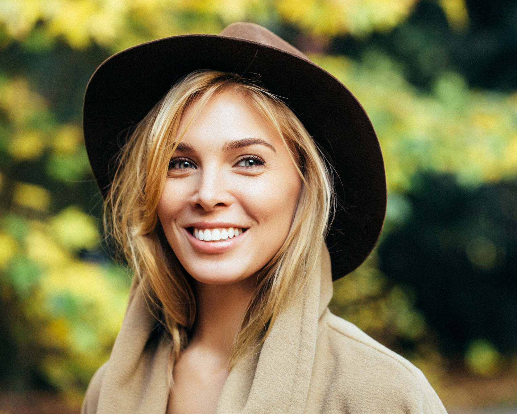 Blonde woman in hat smiling