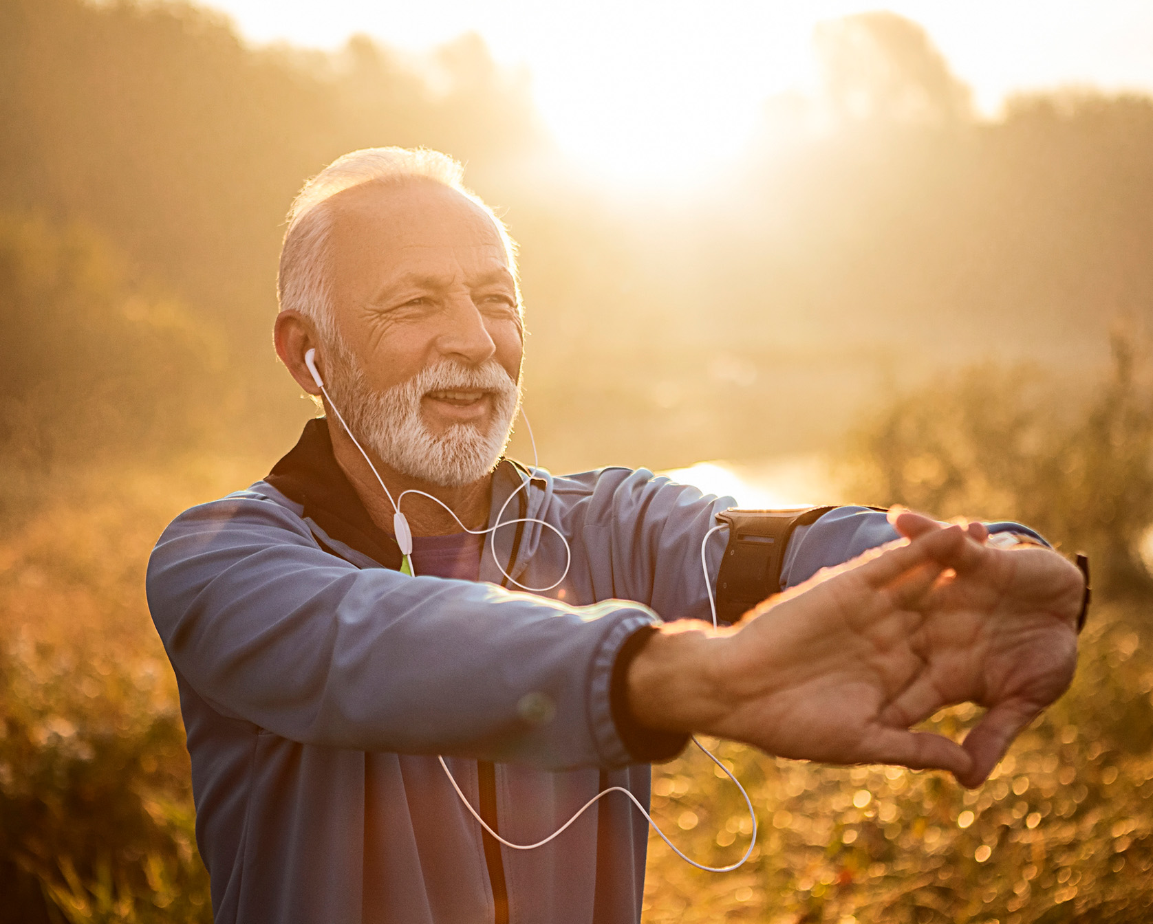 Older man stretching his arms out