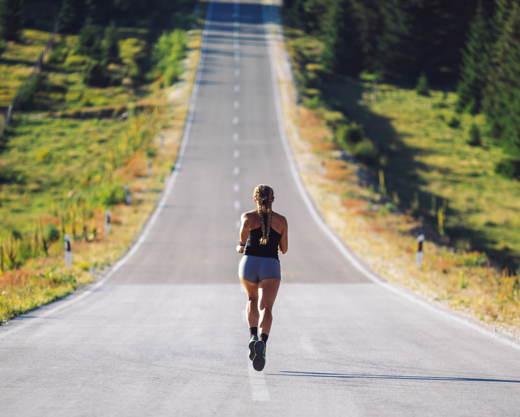Woman running on country road