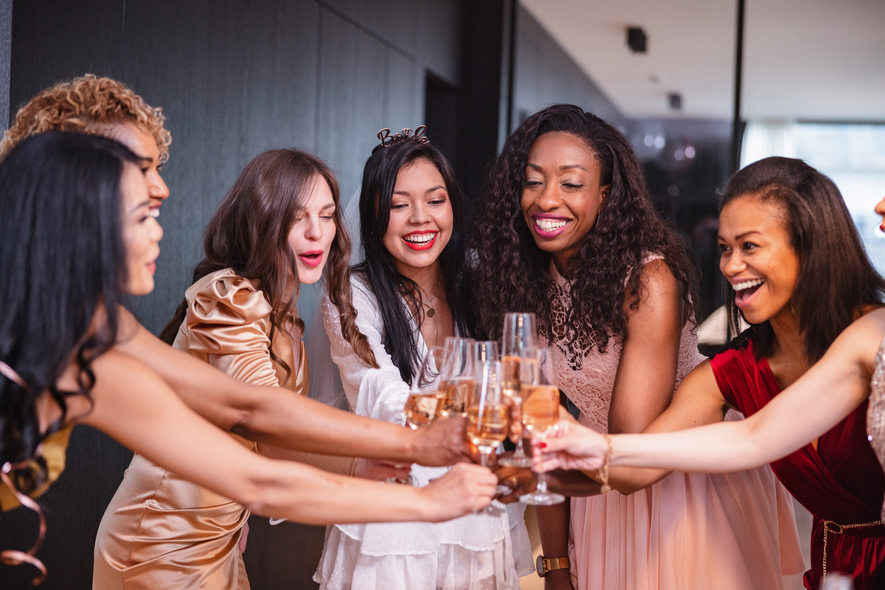 happy group of diverse adult female friends toasting